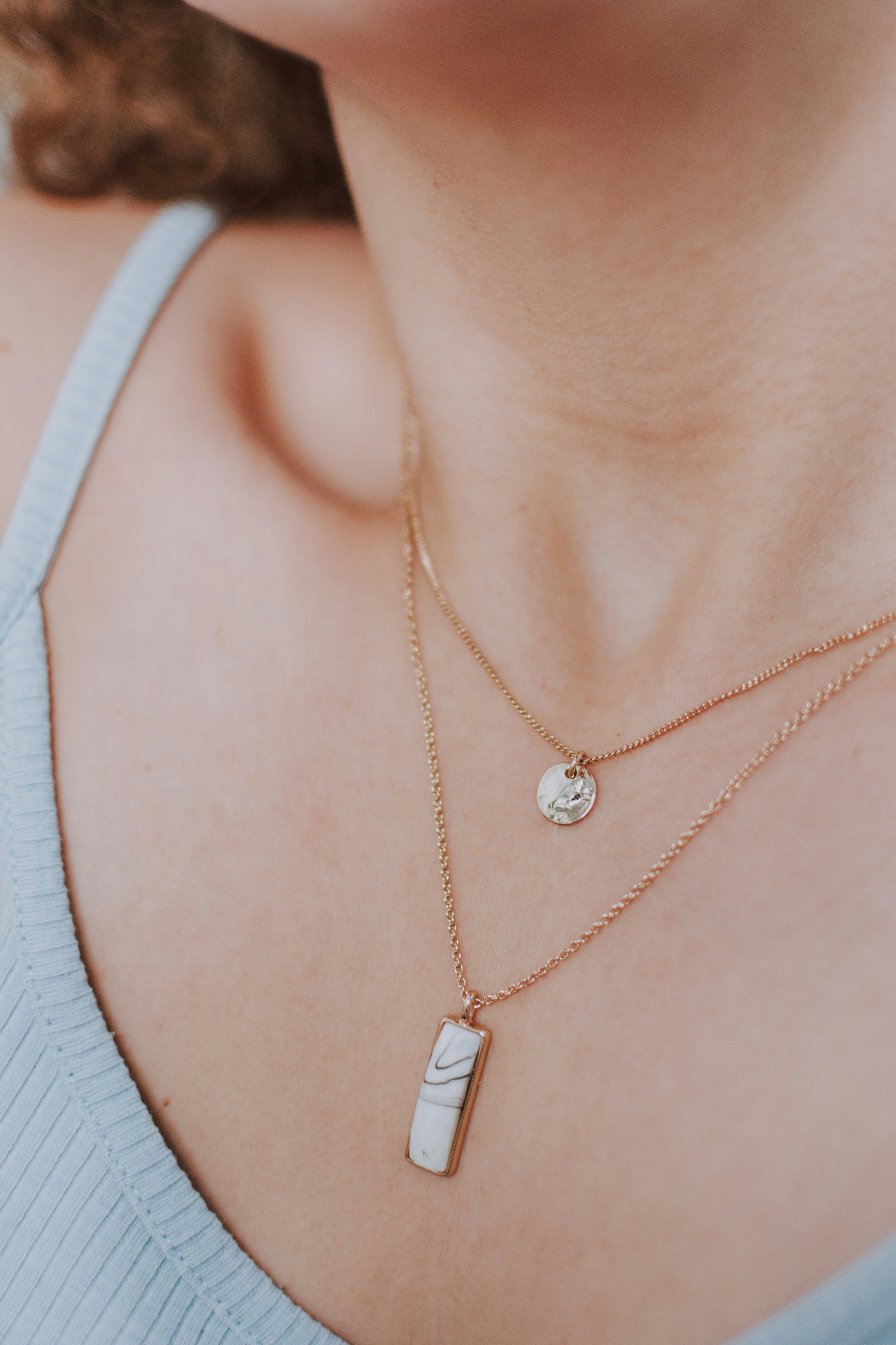 Veliora hero - model wearing gold necklace